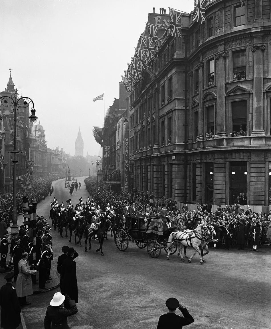 The glass coach, containing the royal newly-weds, Princess Elizabeth and the Duke of Edinburgh, accompanied by an escort of the Household Cavalry, is seen coming up Whitehall towards Admiralty Arch on their way back to Buckingham Palace after their marriage at Westminster Abbey, London on Nov. 20, 1947.