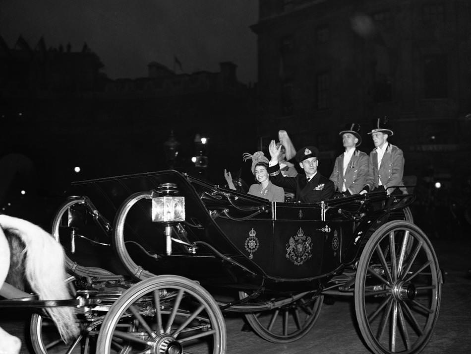The royal newly-weds, Princess Elizabeth and the Duke of Edinburgh, acknowledge the cheers of the crowd as they drove from Buckingham Palace to Waterloo Station in London on Nov. 20, 1947.