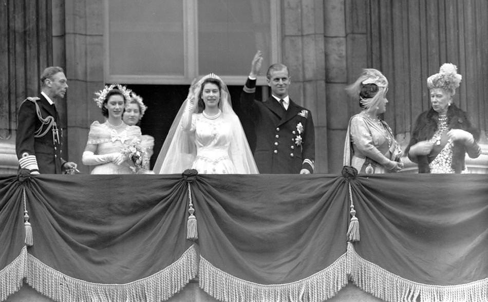 Britain's Queen Elizabeth II, then Princess Elizabeth, and her husband Prince Philip, the Duke of Edinburgh, wave to the crowd from the balcony of Buckingham Palace, London, in this Nov. 20, 1947 photo, after their wedding.