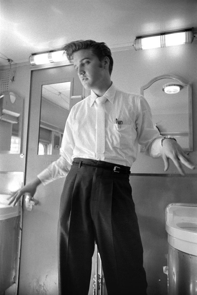 Elvis shaking his hands dry on a train journey back home to Memphis, 1956.