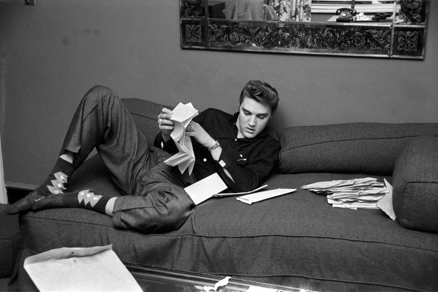 Elvis reading fan mail in his room at The Warwick Hotel, New York, 1956.