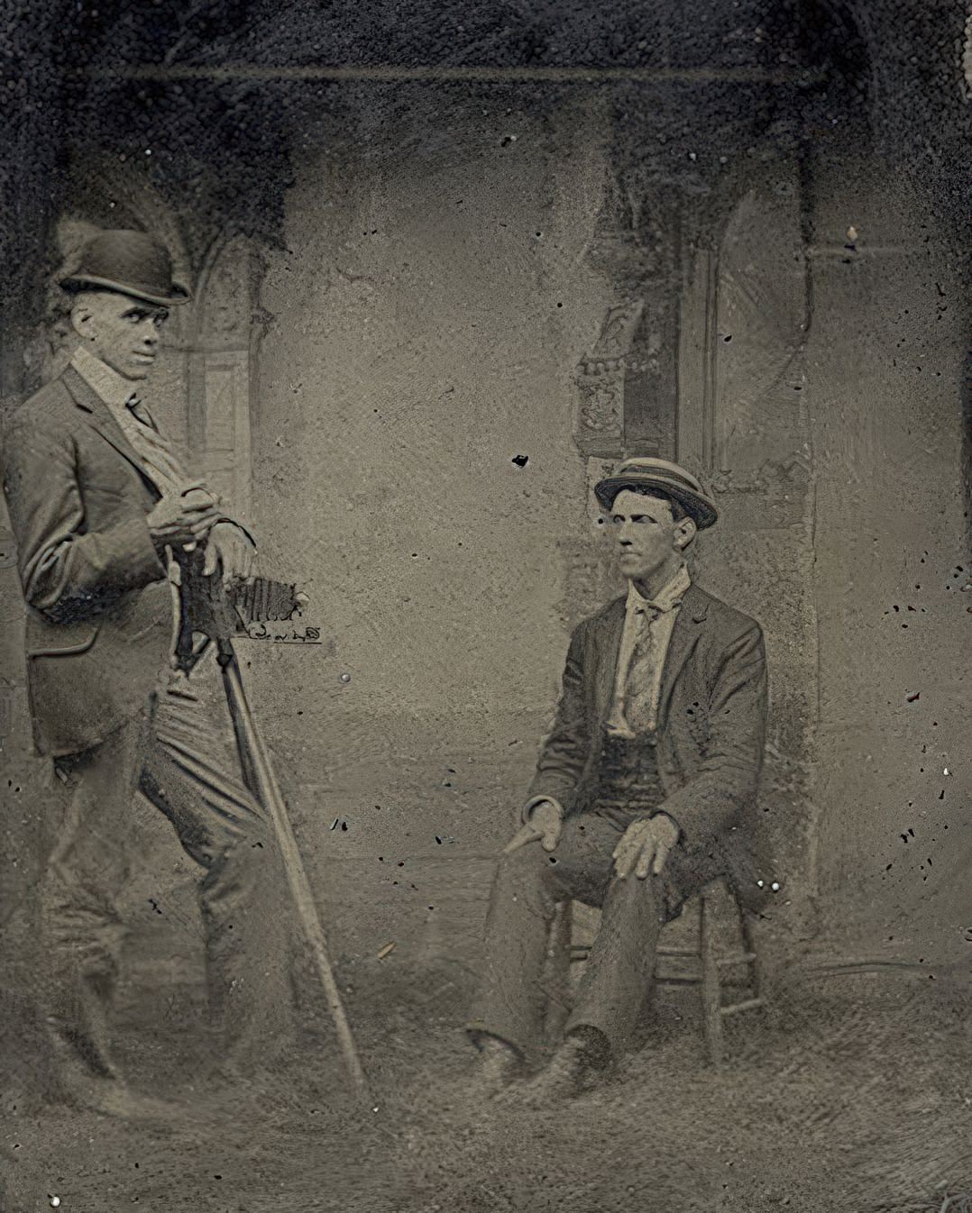 The clumsily hung backdrop says interior but the real looking grass under the two young men says outdoor.