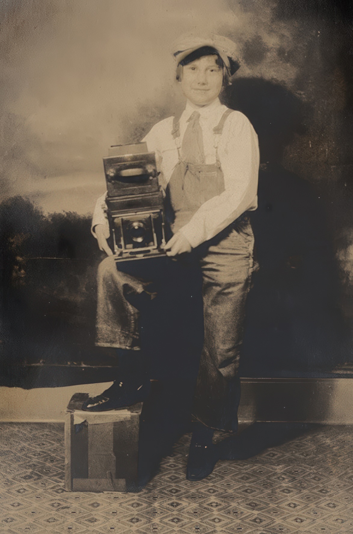 The print shows some free silver in the shadows but the appeal of the young person, a boy we thought, proudly showing off a Graflex type camera was immediate.