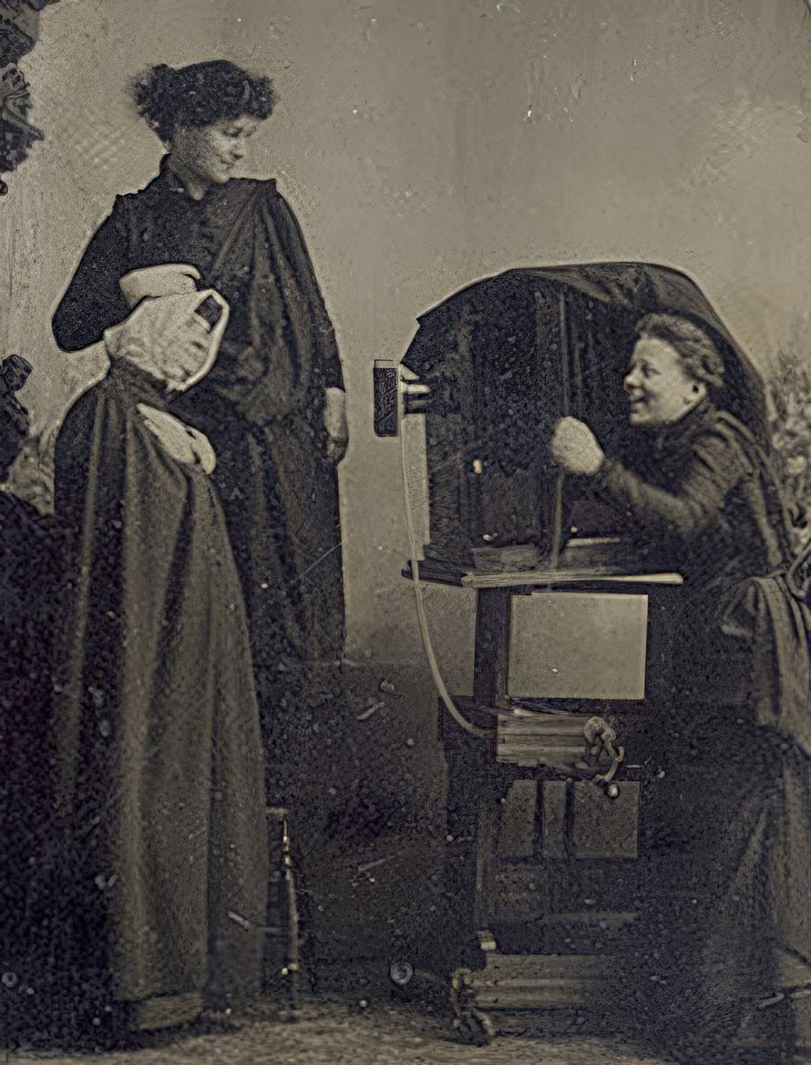 Tintype of 3 young women with studio camera. The cryptic writing reads "The Three Damnid" or "Danmid" Wilhemina Greek Slave & Damnid or Danmid". Perhaps they were referring to the Danaïds, daughters of Danaüs in Greek mythology painted by Burne-Jones. "Greek Slave" seems to be a reference to Hiram Powers famous stature but these young ladies are certainly more completely dressed than she! Wilhemina has defeated us as an art history reference.