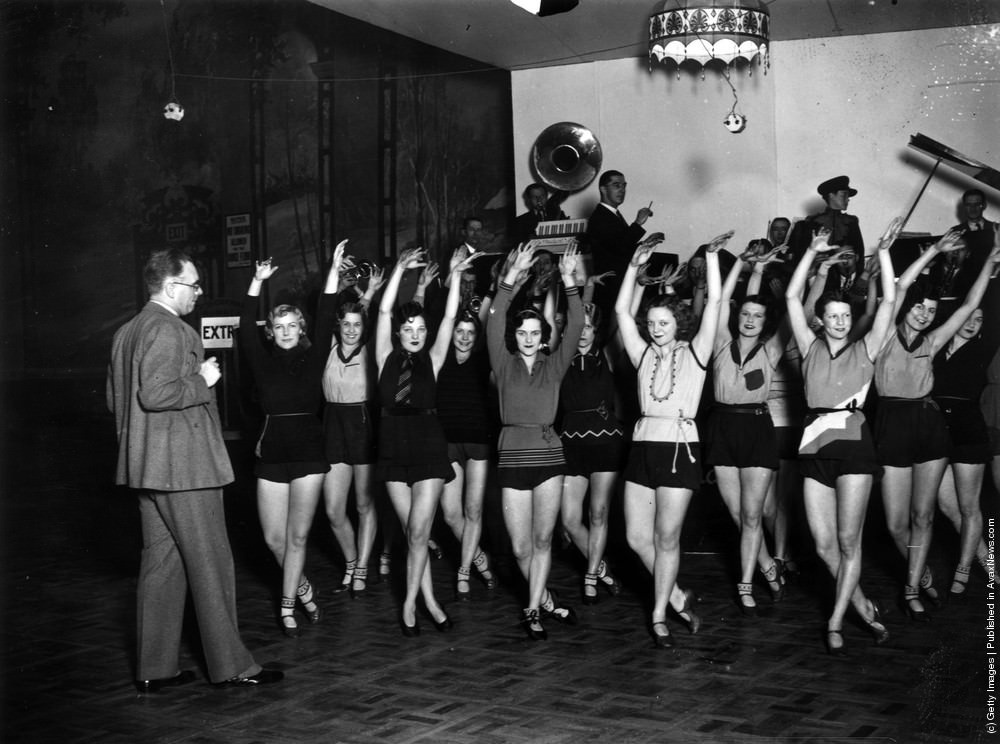 Andre Charlot rehearsing his chorus for the Grand Ball at the Royal Opera House, London, 1929.