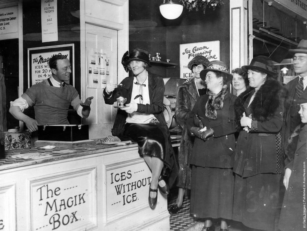 Leslie Henson serving ice cream to Dorothy Dickson at the Daily Express Women's Exhibition, London, 1923.