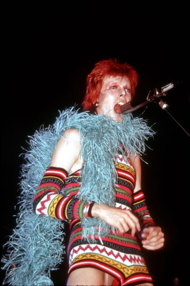 David Bowie in a blue feather boa performing in Los Angeles, 1973.