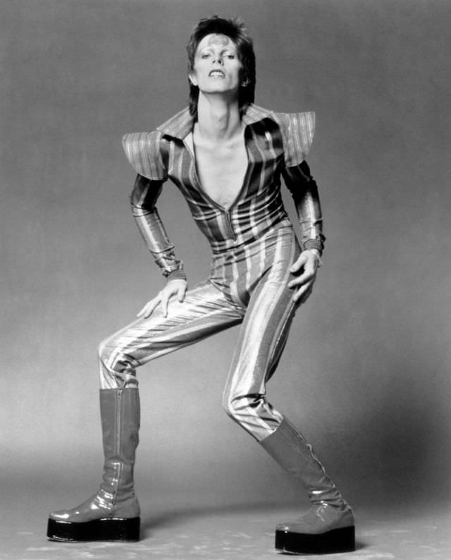 David Bowie in a striped jumpsuit and platform boots as Ziggy Stardust in London, 1972.
