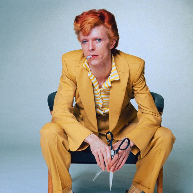 David Bowie in a yellow suit for a promo photo, 1974.