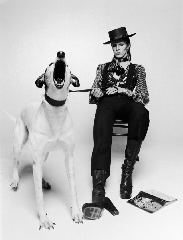 David Bowie in a top hat, heeled boots, and overalls for his Diamond Dogs album promo, 1974.