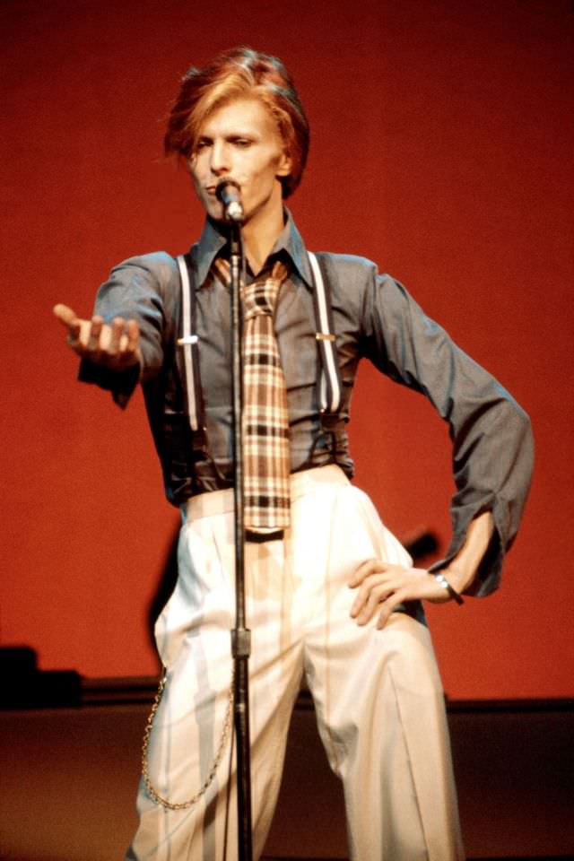 David Bowie in suspenders and a plaid tie performing at Radio City Music Hall during the Philly Dogs Tour, 1974.