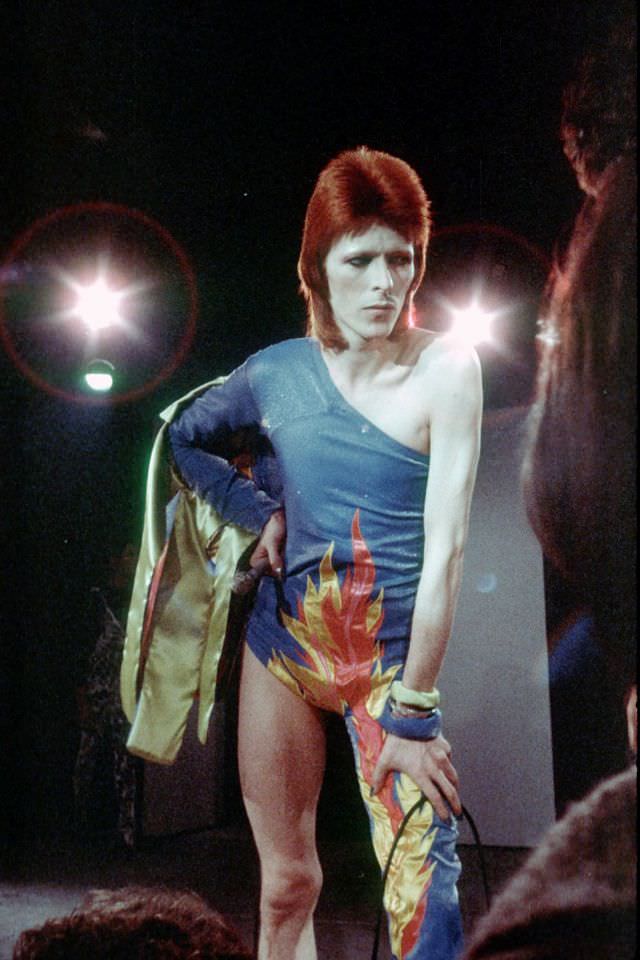 David Bowie in an asymmetrical bodysuit performing onstage as Ziggy Stardust, 1972.