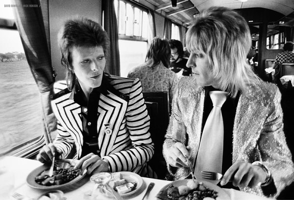 David Bowie and Mick Ronson having lunch on a train, 1973.