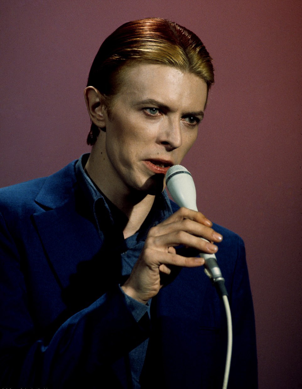 David Bowie with a microphone in Los Angeles, 1975.