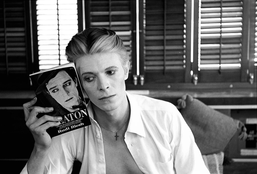 David Bowie holding a Buster Keaton book, New Mexico, 1975.