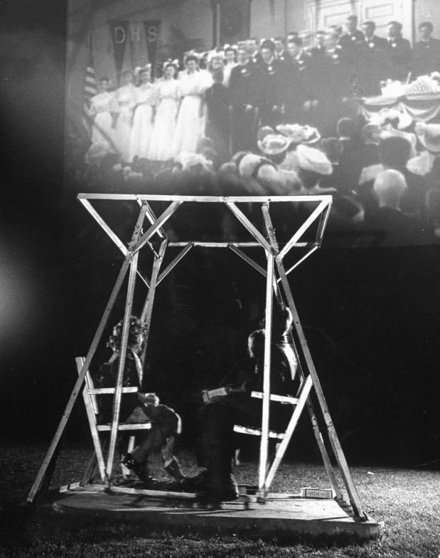 Kids enjoy one of the four double-seated glider swings in the mini-playground at the Rancho Drive-In Theater, San Francisco, 1948