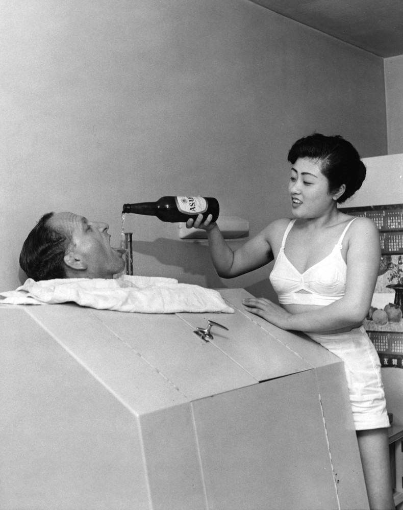 A Geisha girl pouring a drink, 1950s.