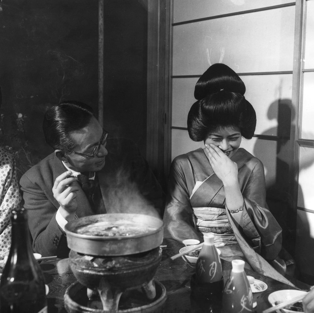A Geisha girl laughing shyly, 1950s.