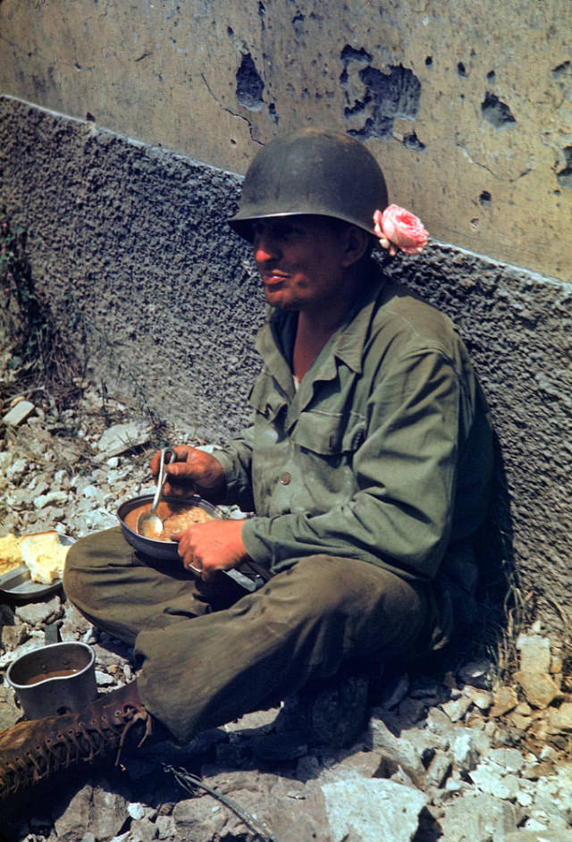 An American soldier taking a meal break during the drive towards Rome, 1944.