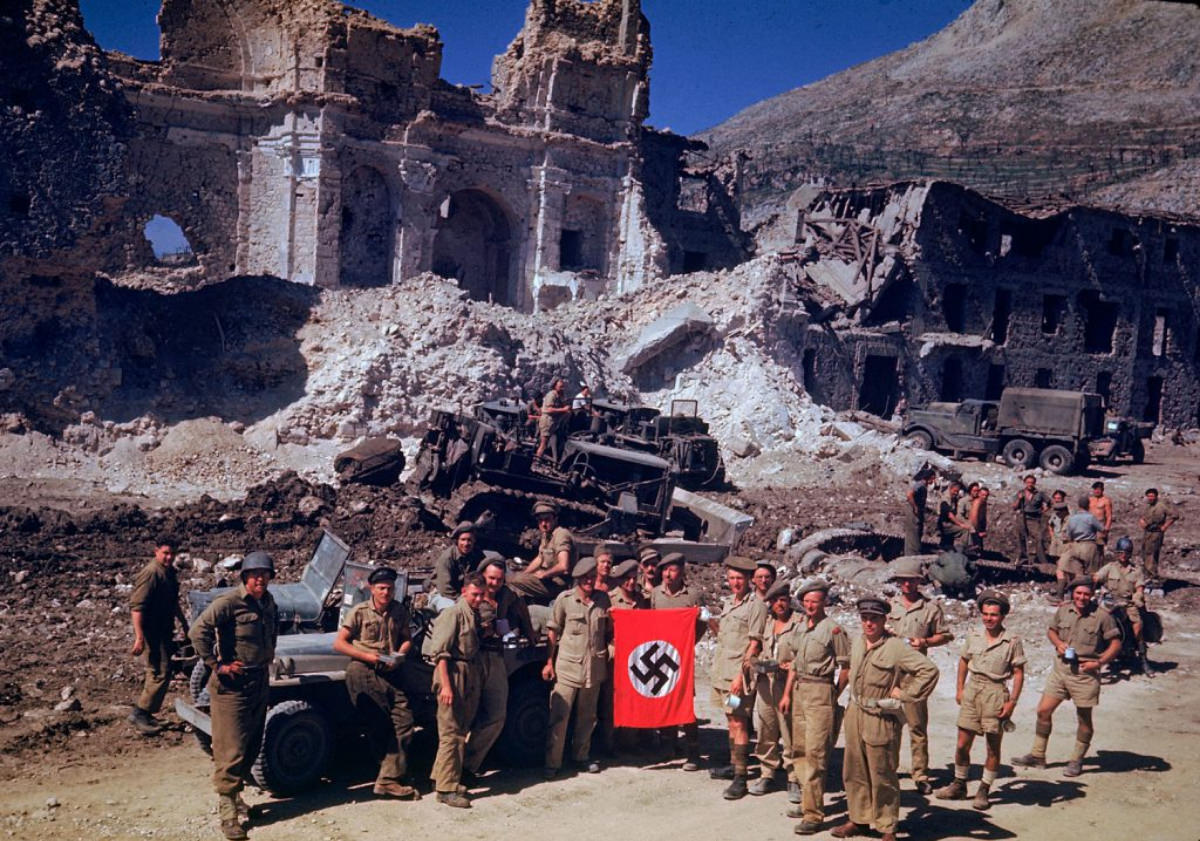 British and South African soldiers with a captured Nazi flag during the Italian Campaign, World War II, 1940s.
