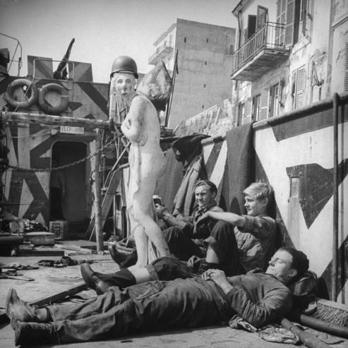 American soldiers with their mascot, "Axis Sally," at Anzio, 1944.