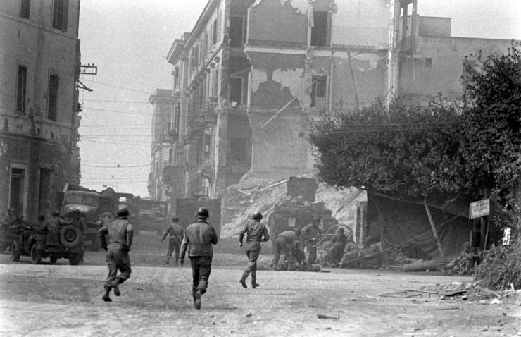 Troops attending to a wounded comrade at Anzio, 1944.