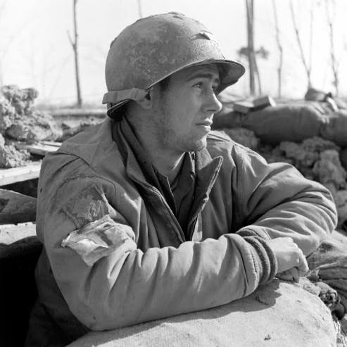 Medic Pvt. E. Armitage sunbathing at Anzio, 1944.