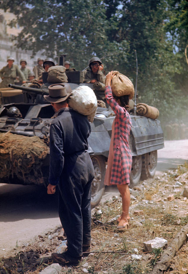 Italians watched American armor pass during the drive towards Rome along the Appian Way, World War II, 1940s.