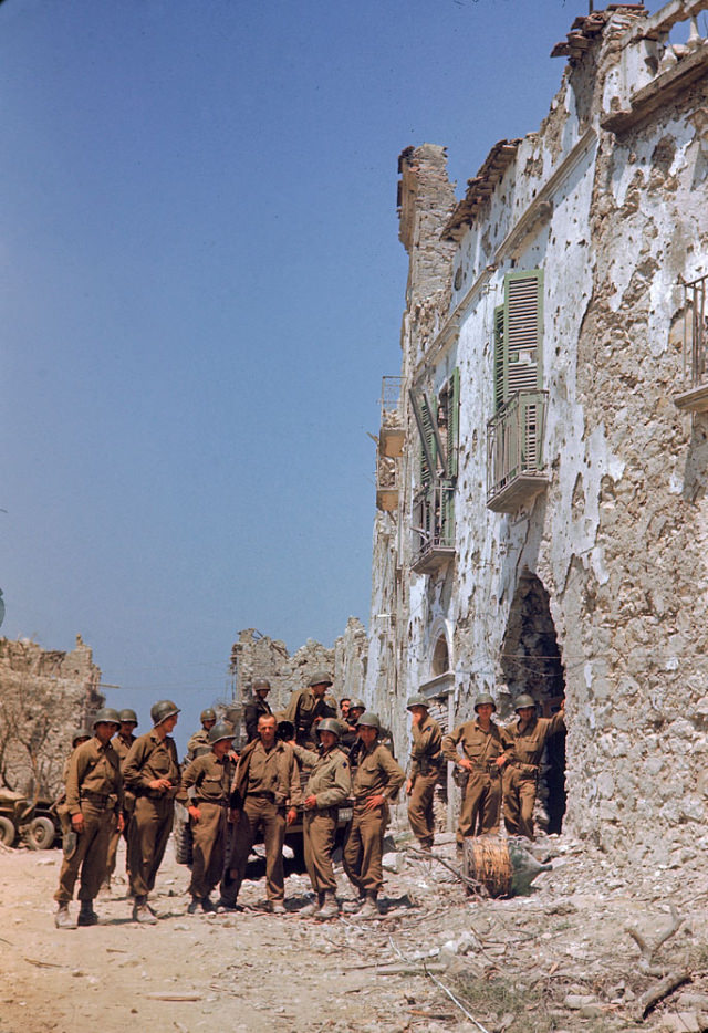 American troops stood in front of a bombed-out building during the drive towards Rome, World War II, 1940s.