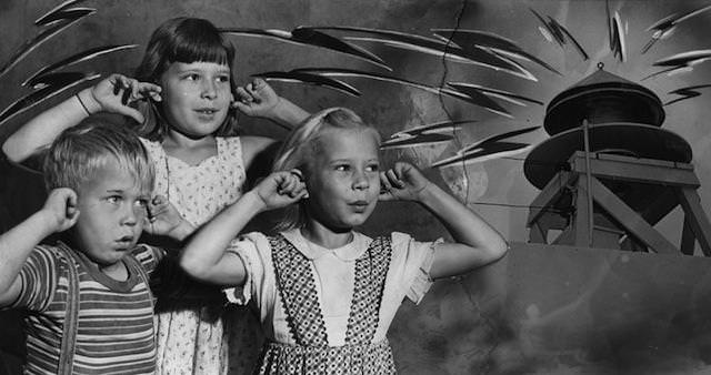 The Hubik children—Julius, 6; Suerita, 10, and Margie, 7— voiced their reaction today to the wailing of Los Angeles' air raid sirens and ringing of church bells at noon as Fourth of July was celebrated. The blast also served as a country-wide test for the air raid sirens. July 4, 1951.