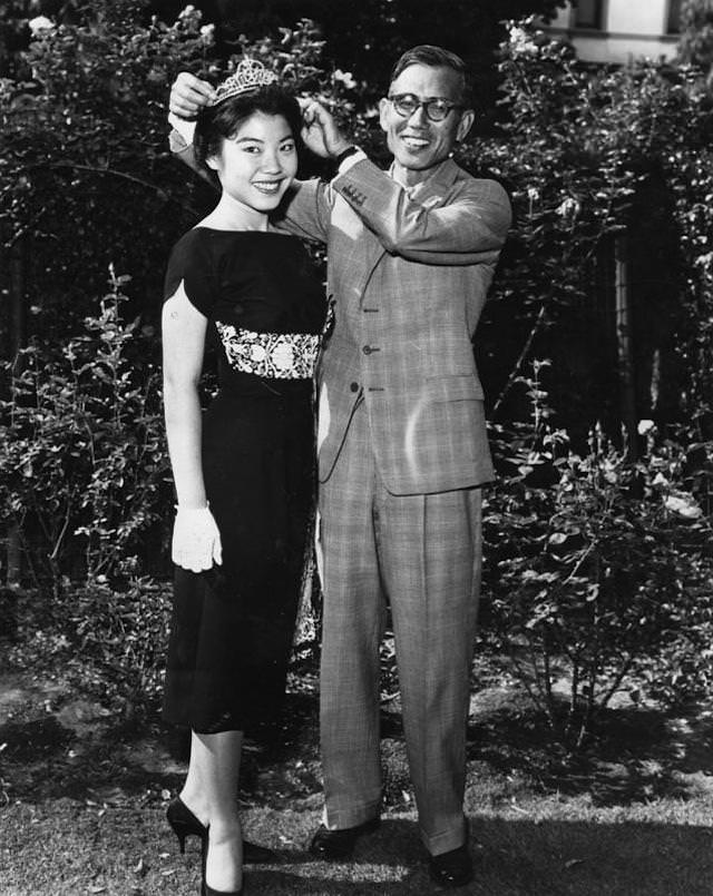 Ayleen Ito, 18, is crowned as queen of 27th annual American Legion Fourth of July fireworks show at Coliseum by Yukio Hasumi, consul-general of Japan in Los Angeles. June 24, 1959.