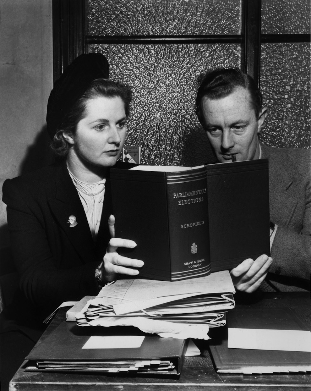 Aged 24. Margaret Roberts consults a parliamentary refence book with a colleague during her time campaigning.