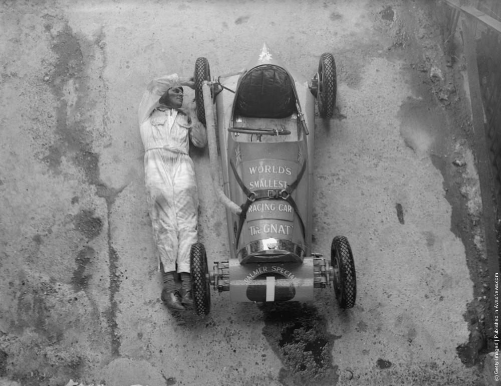 The length of an adult male, Jean Reville's midget car, “the gnat” (claimed to be the world's smallest racing car) being given an overhaul by a mechanic in preparation for a Jubilee meeting being held at White City, London. 16th April 1935.