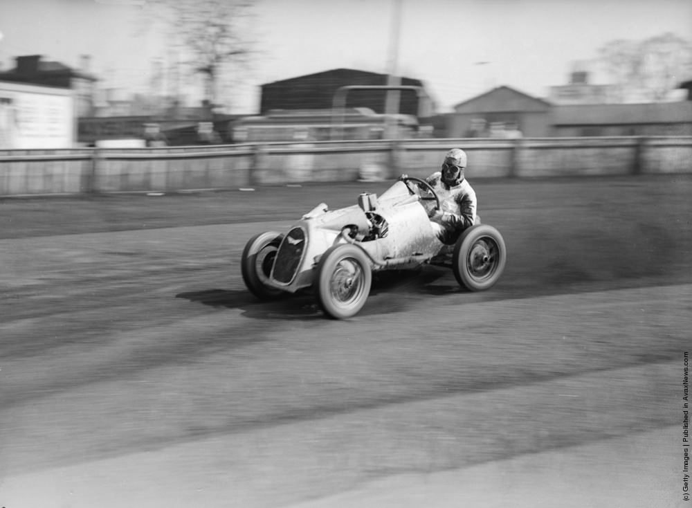Midget car speedway champion of Great Britain Jean Reville breaks the four lap record at Lea Bridge speedway in his midget car “Palmer's Special”. The tiny car is 5 feet long and 3 ft 6 inches wide and it runs on a 9 horsepower engine. 10th April 1935.