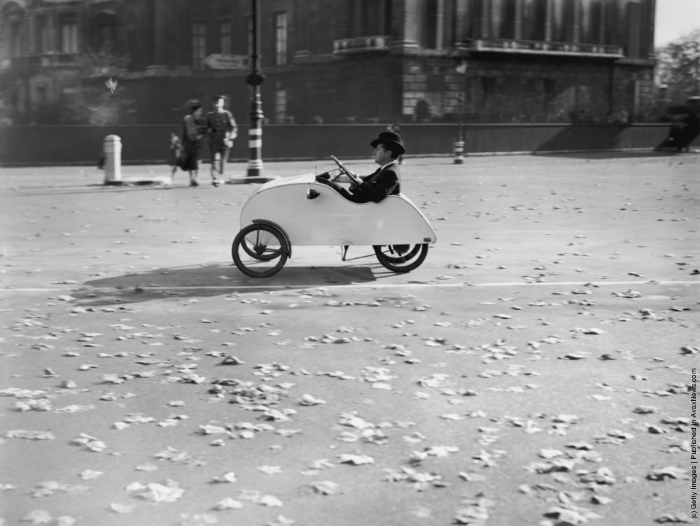 A tiny “Velocar” with “double-pedal” movement is showing its paces in Hyde Park, London, solving the problem of wartime petrol rationing. 1939.