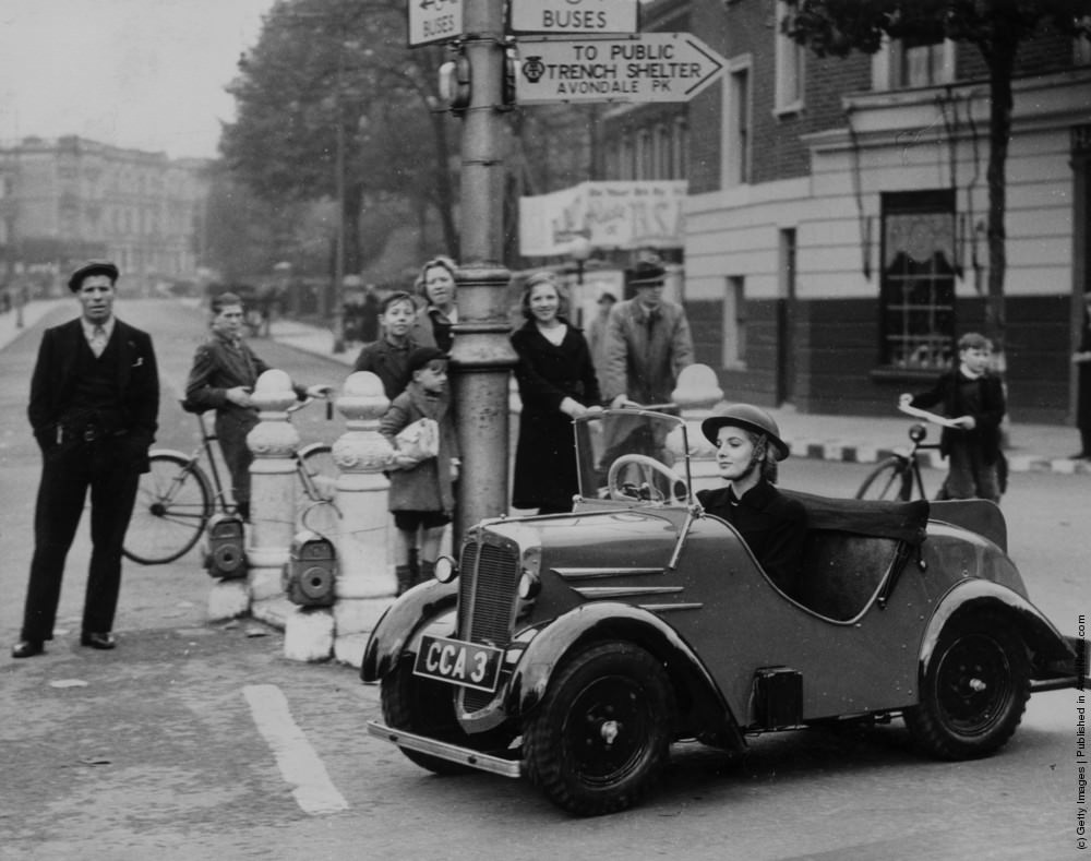 A woman driving the new solution to the problem of wartime petrol rationing, the midget car. This tiny vehicle can cover eighty miles on a gallon of petrol and achieves speeds of up to 45 miles per hour. 26th October 1939.