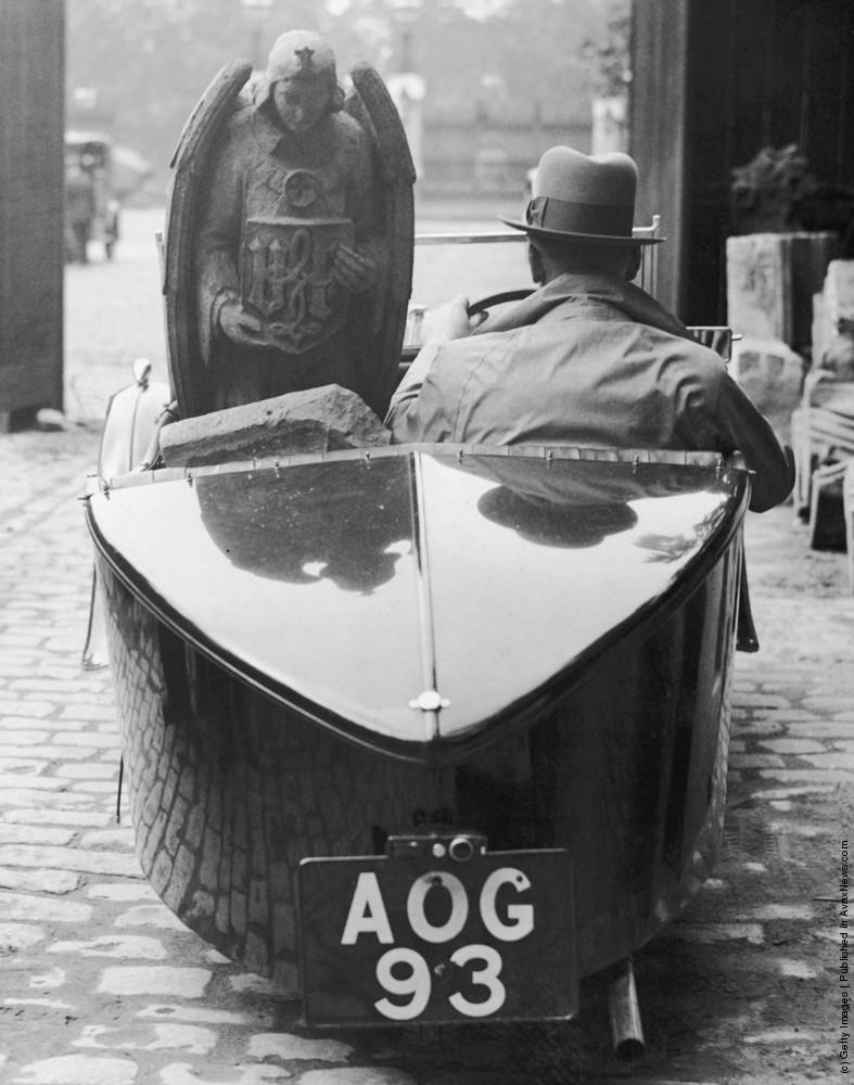 A motorist leaving the Houses of Parliament in London with an angel for which he has paid ten guineas. 1934.