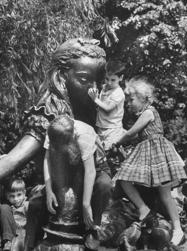 In a wonderland for climbers a bronze Alice is cluttered with children who have scrambled over Mad Hatter and other Lewis Carroll creatures