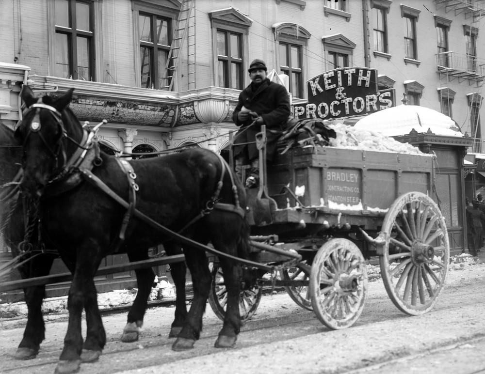 Cleaning snow from New York City streets in trucks, January 1908.