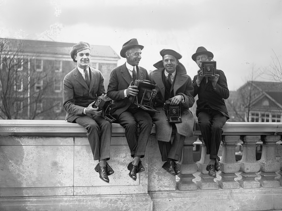 Four unidentified photographers from the early 1900s hanging out with their cameras in hand.
