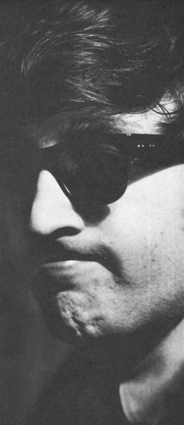 John Lennon looking grumpy.