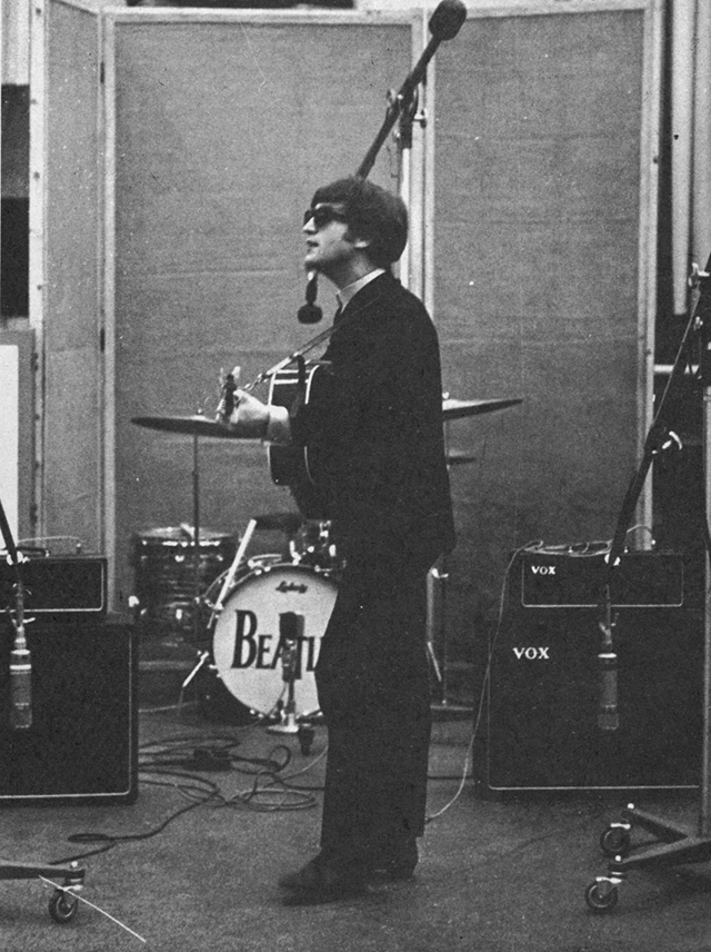 John Lennon playing guitar.