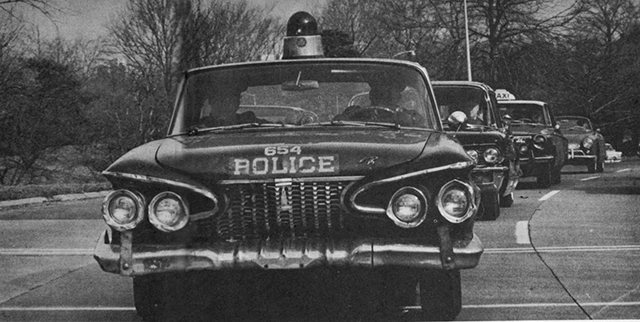 The Beatles receiving a police escort.