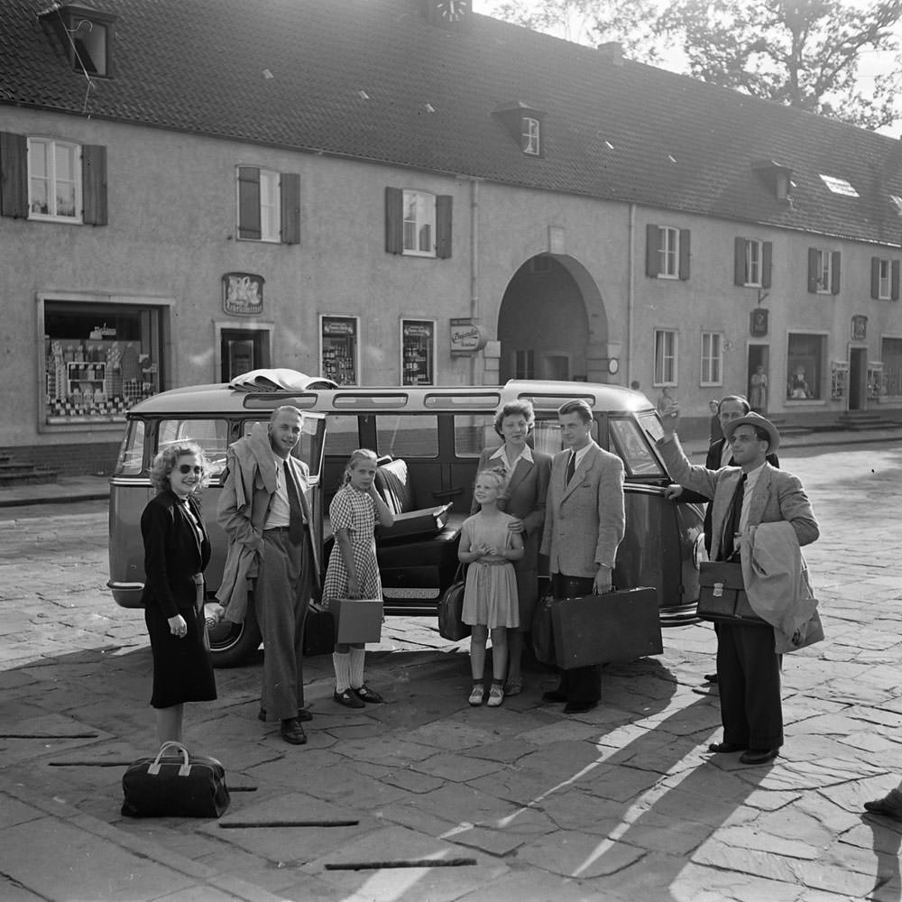 People gathered around a VW bus, 1951.