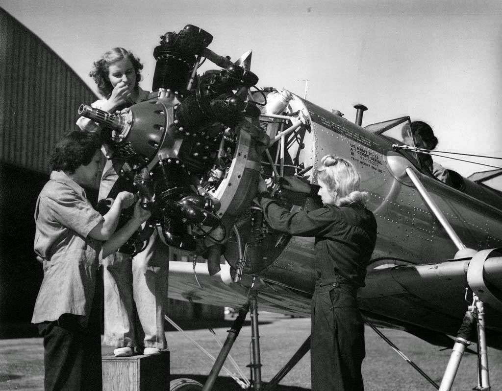 Women mechanics working on an airplane, World War II