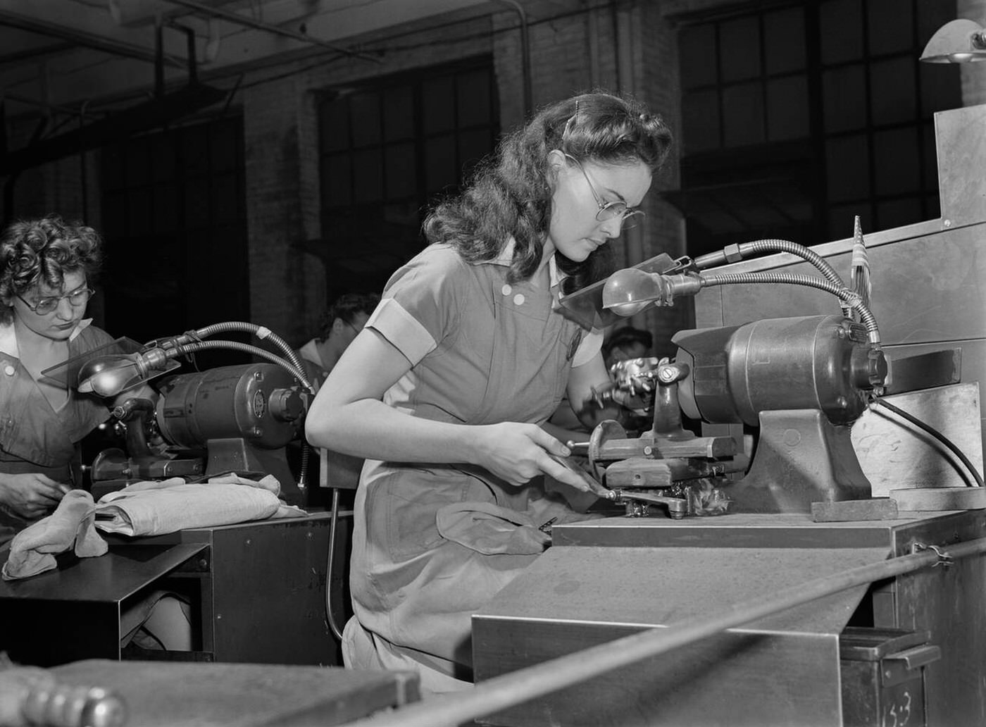 Female factory workers operating machinery, 1942