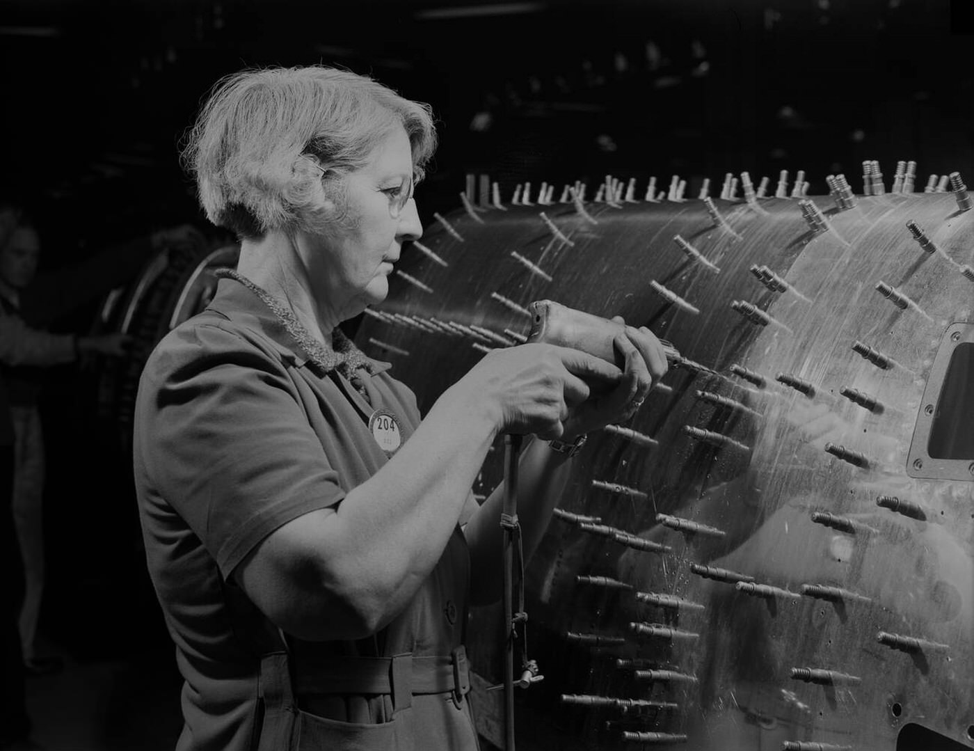 A female worker drilling holes in a B-17, 1942