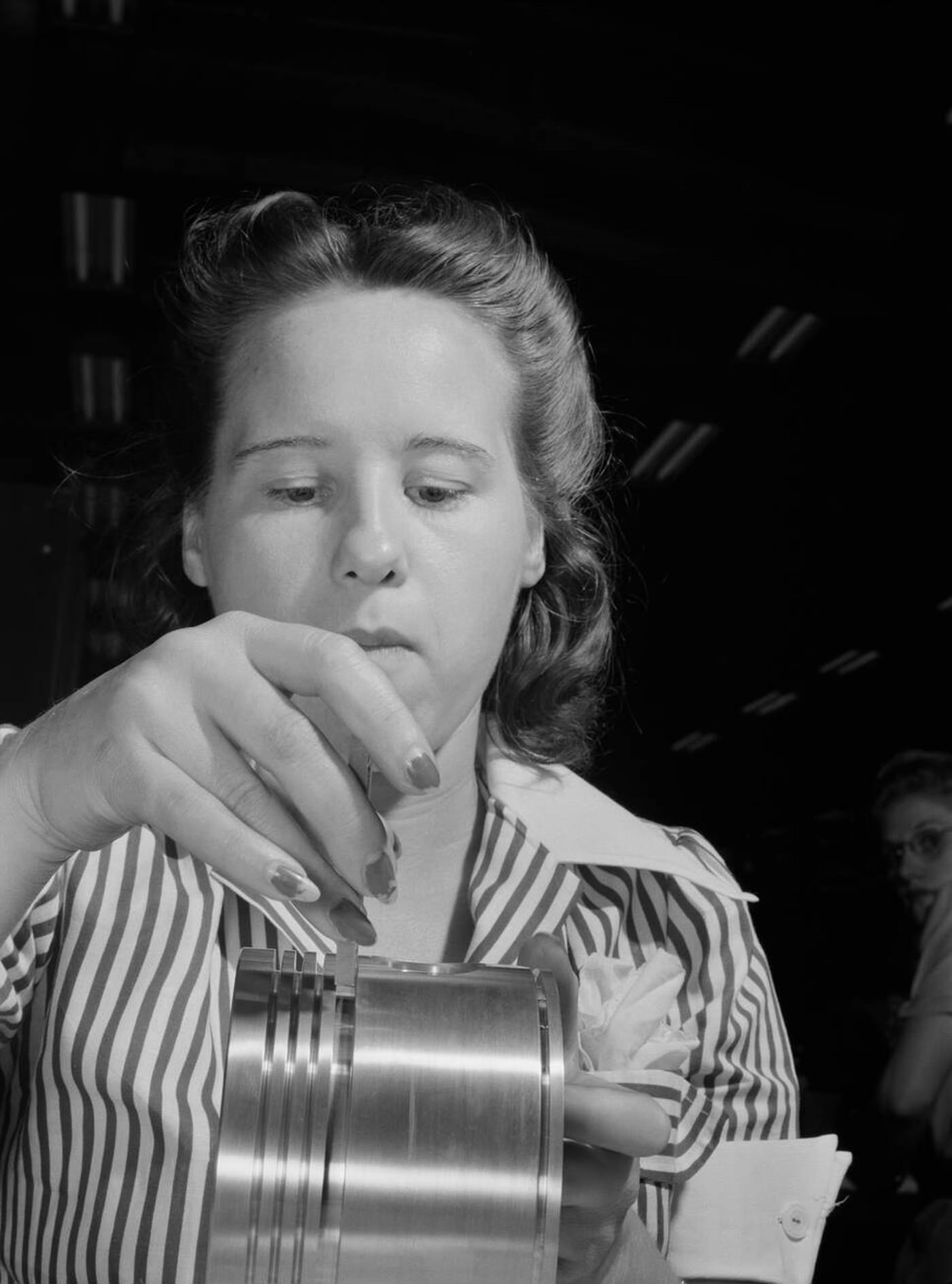 Anne Weinman inspecting pistons, 1942