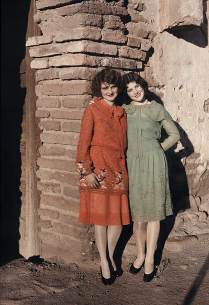 Two Mexican girls pose against a brick wall in Nogales, ca. 1920s.