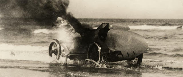 A car on fire, the driver managed to drive into the sea and jump out, England, 1926.